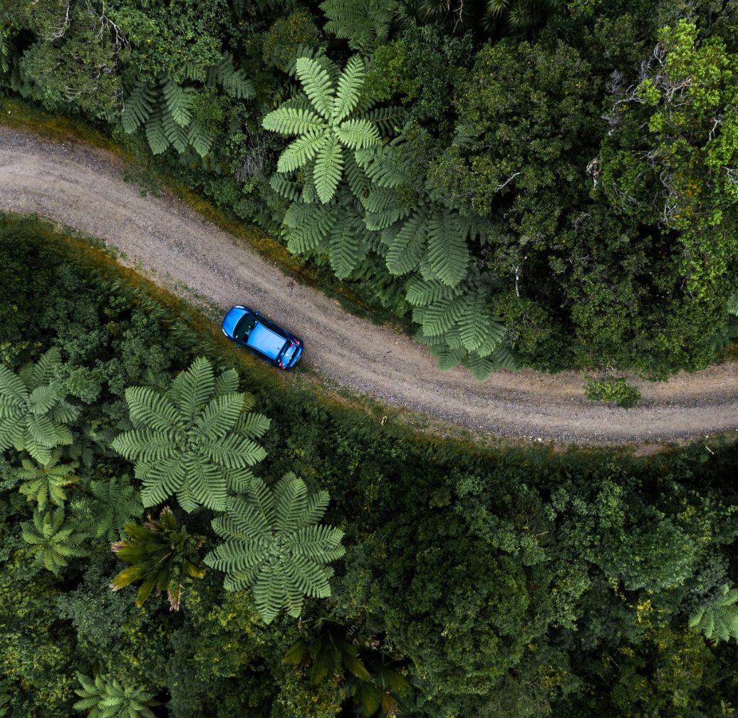 Aerial of a Hertz hire car on a forest road